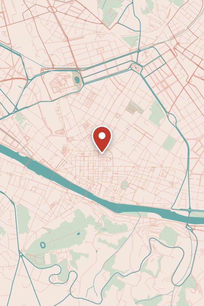 Central Florence's streets drawn in coral and teal on peach, with the river curving through and a red pin near the cathedral.