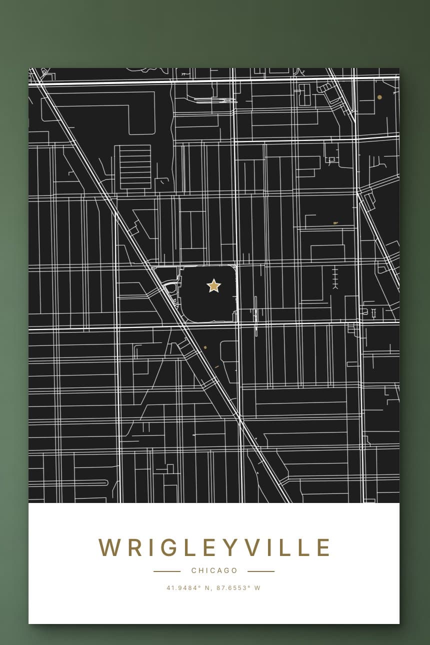 A black and white city map poster of Wrigleyville in Chicago with a gold star on Wrigley Field, hanging on a sage green wall.